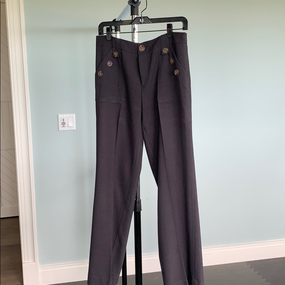 Navy slacks with brown pocket button accent